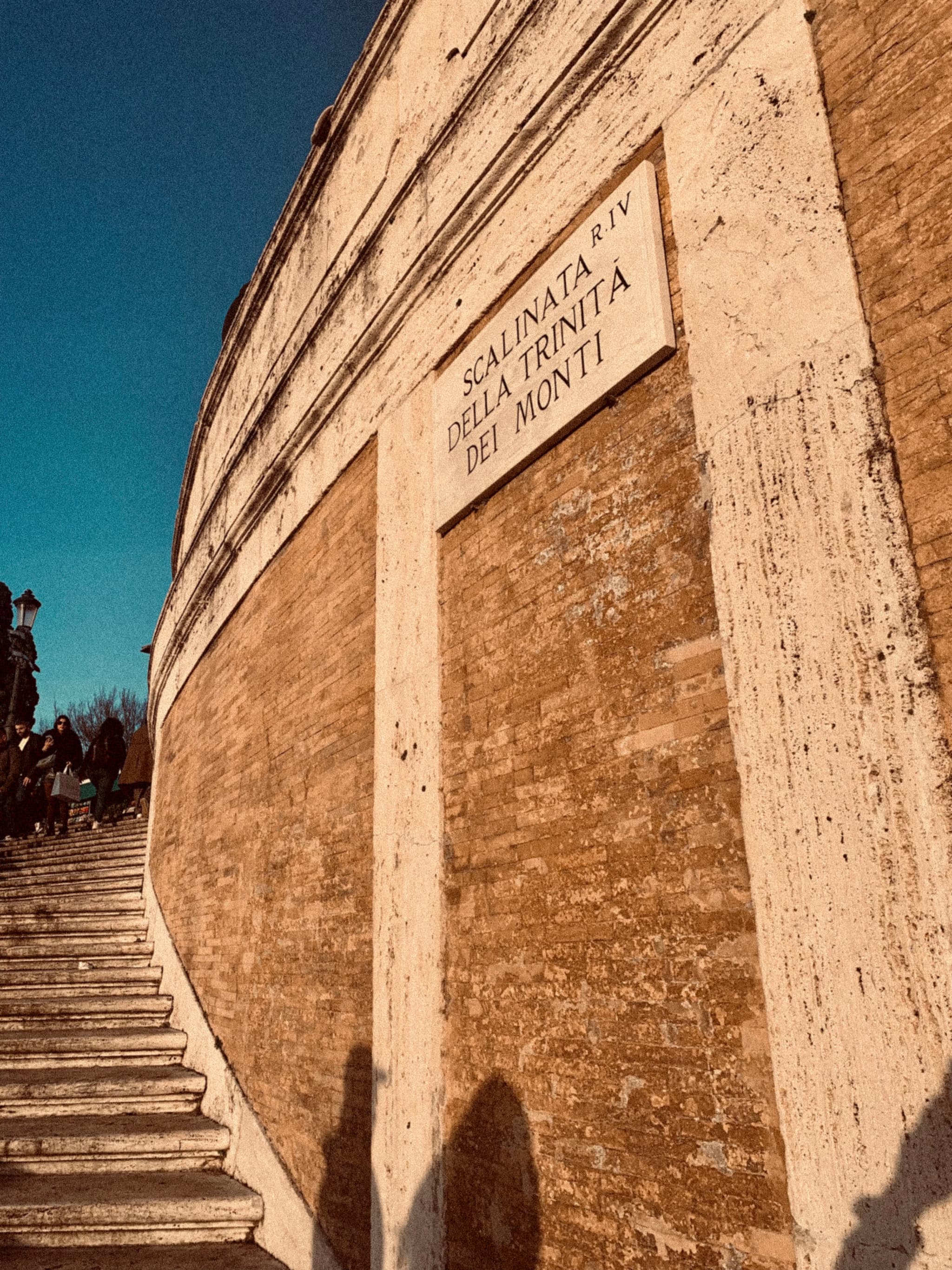 low angle view of the stone steps at scalinata della trinita dei monti in rome under clear blue sky during golden hour